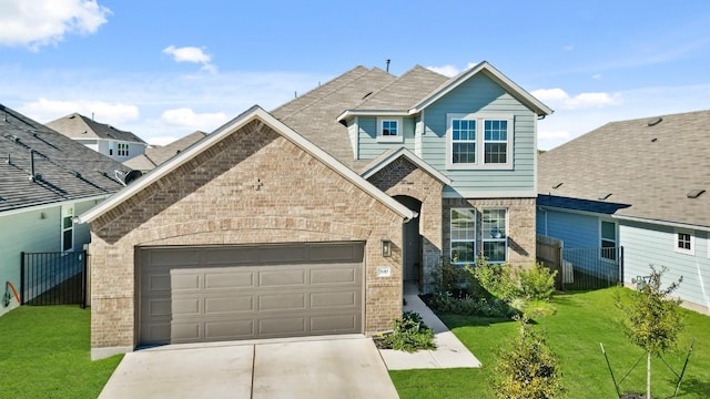 view of front of home featuring concrete driveway, an attached garage, fence, a front lawn, and brick siding