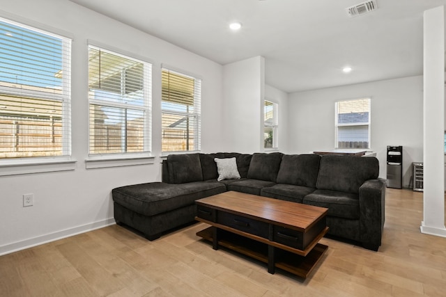 living room with plenty of natural light and light wood-type flooring