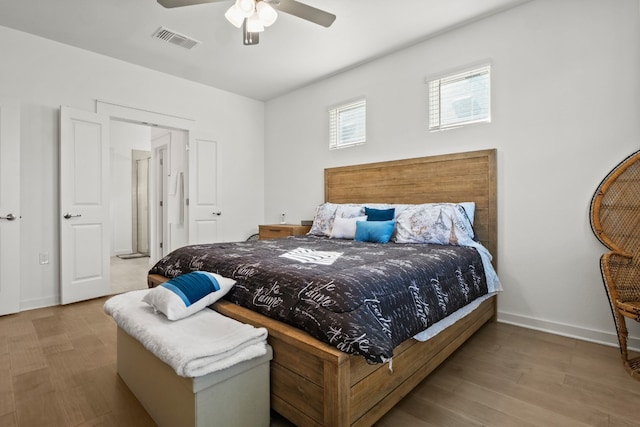 bedroom with ceiling fan and light hardwood / wood-style floors