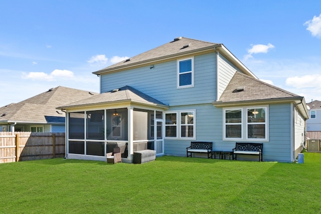 rear view of house with a sunroom, cooling unit, and a lawn