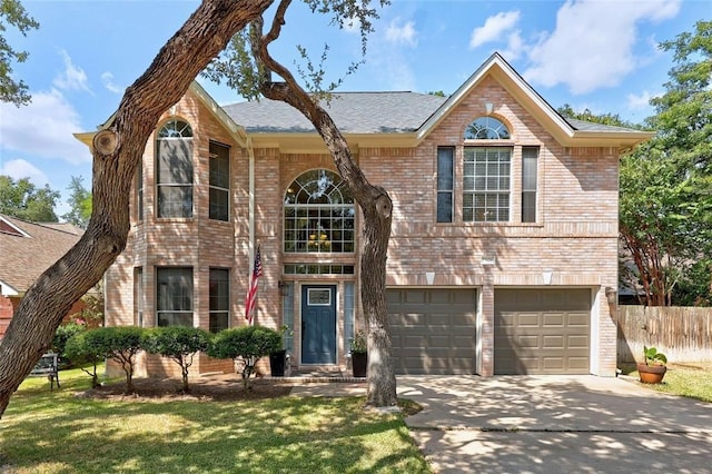 view of front of property featuring a front yard and a garage