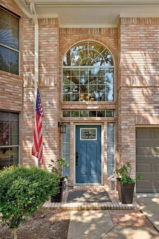 view of exterior entry featuring a garage