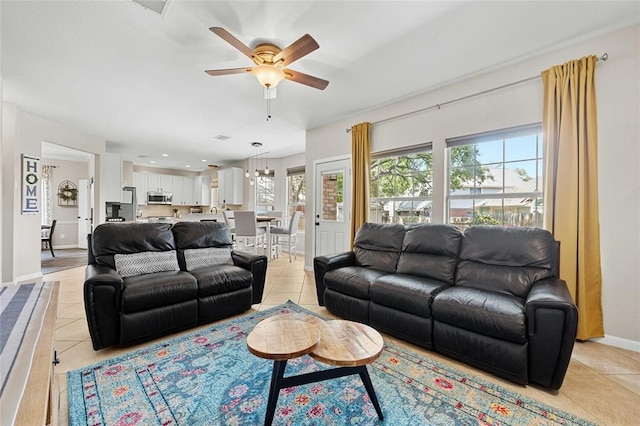 living room featuring ceiling fan and light tile patterned flooring