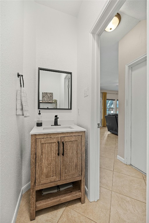 bathroom featuring tile patterned flooring and vanity