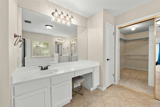 bathroom with tile patterned floors and vanity