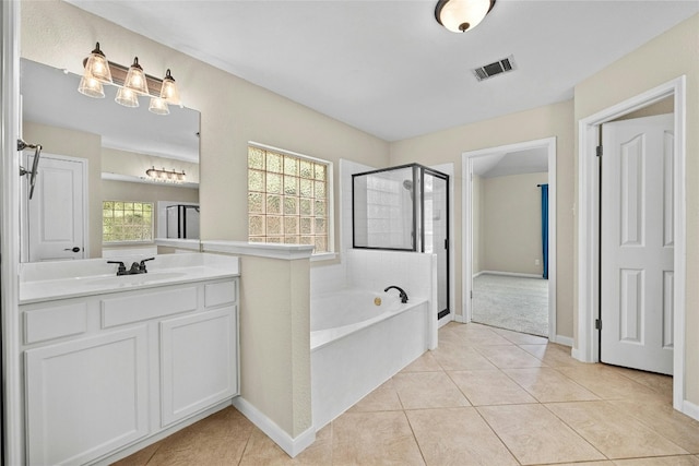 bathroom with tile patterned flooring, vanity, and independent shower and bath