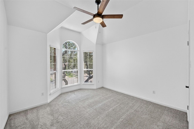 carpeted empty room with ceiling fan and vaulted ceiling