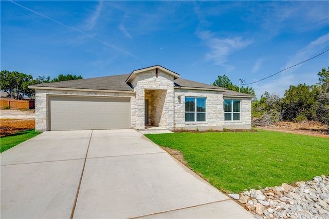 view of front of property with a front yard and a garage