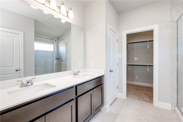 bathroom with tile patterned floors, vanity, and an enclosed shower