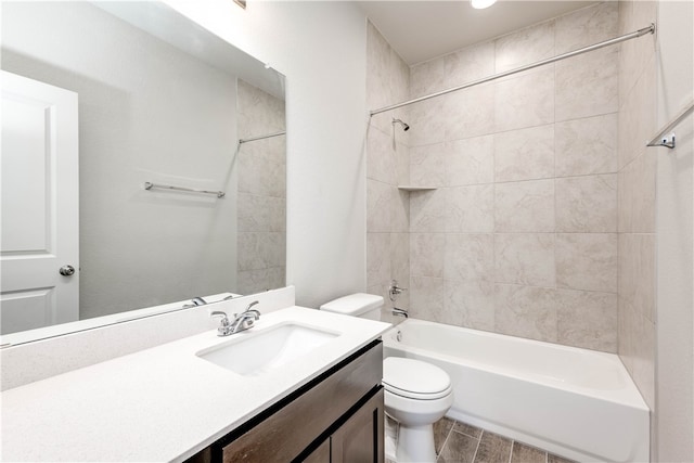 full bathroom featuring vanity, toilet, and tiled shower / bath