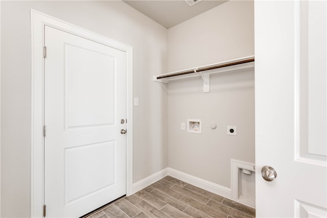 washroom featuring washer hookup, light hardwood / wood-style floors, hookup for a gas dryer, and electric dryer hookup