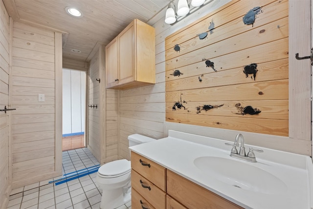 bathroom with vanity, wooden ceiling, tile patterned flooring, toilet, and wood walls