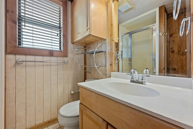 bathroom with vanity, toilet, and an enclosed shower