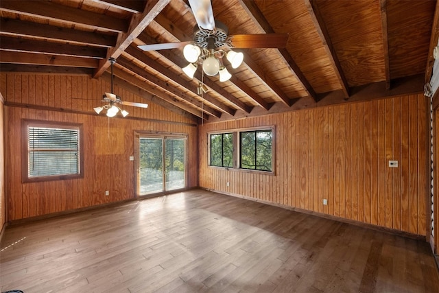 empty room featuring wooden walls, light hardwood / wood-style flooring, and ceiling fan