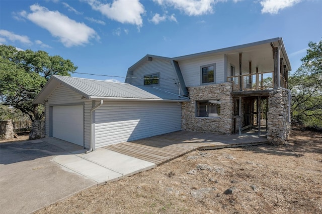 view of front of property featuring a balcony and a garage