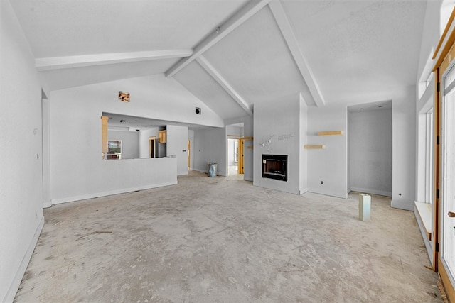 unfurnished living room featuring beam ceiling, a large fireplace, and high vaulted ceiling