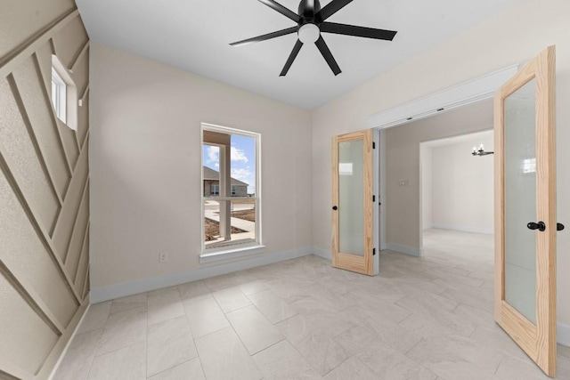 spare room with french doors and ceiling fan