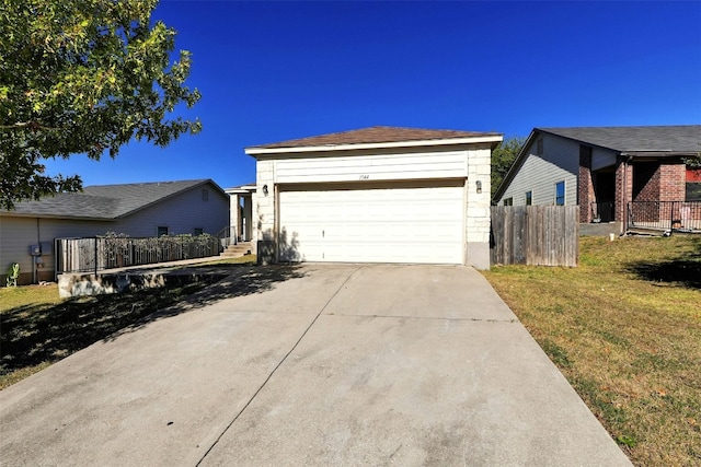 view of front of house featuring a garage and a front lawn