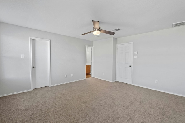 unfurnished bedroom featuring ceiling fan, carpet floors, visible vents, and baseboards