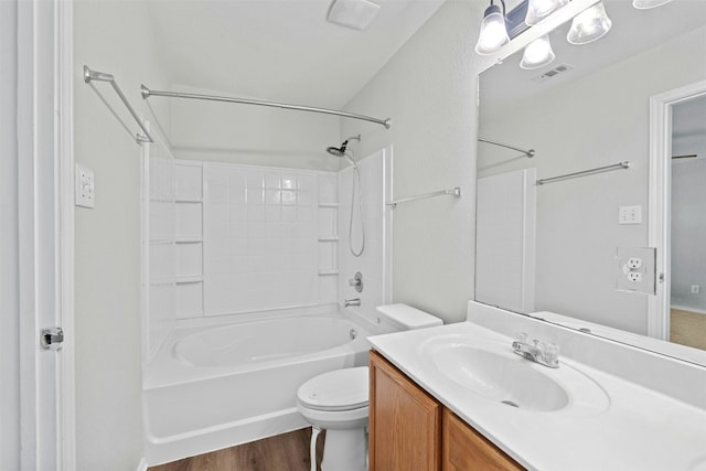 full bath featuring visible vents, toilet, wood finished floors, tub / shower combination, and vanity