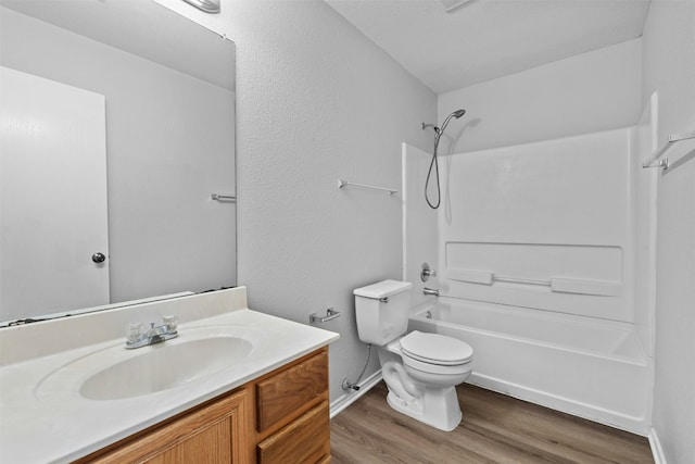 full bathroom with toilet,  shower combination, wood finished floors, and vanity