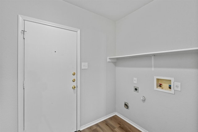 clothes washing area featuring laundry area, hookup for a gas dryer, wood finished floors, hookup for a washing machine, and hookup for an electric dryer