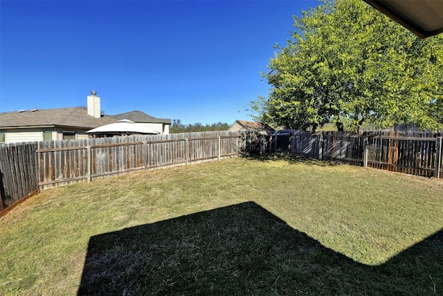 view of yard featuring a fenced backyard and a gazebo