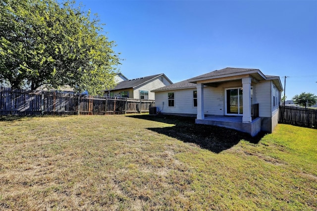 rear view of property featuring a patio, a lawn, a fenced backyard, and central air condition unit