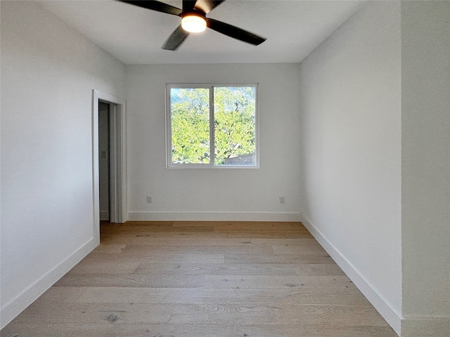 empty room with ceiling fan and light hardwood / wood-style flooring