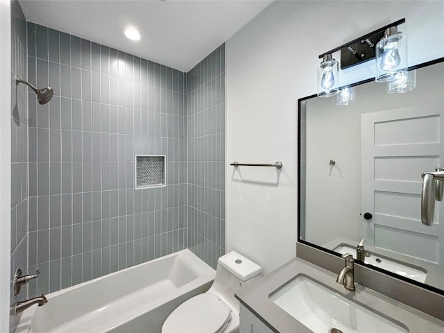 full bathroom featuring vanity, toilet, and tiled shower / bath