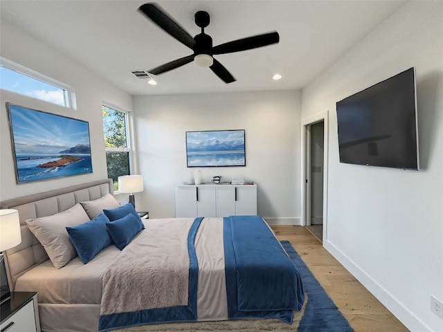 bedroom with ceiling fan and light wood-type flooring