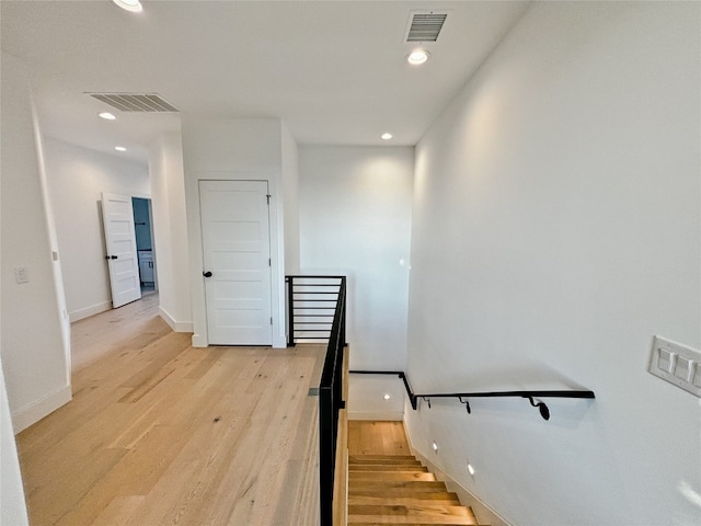 stairs featuring hardwood / wood-style flooring