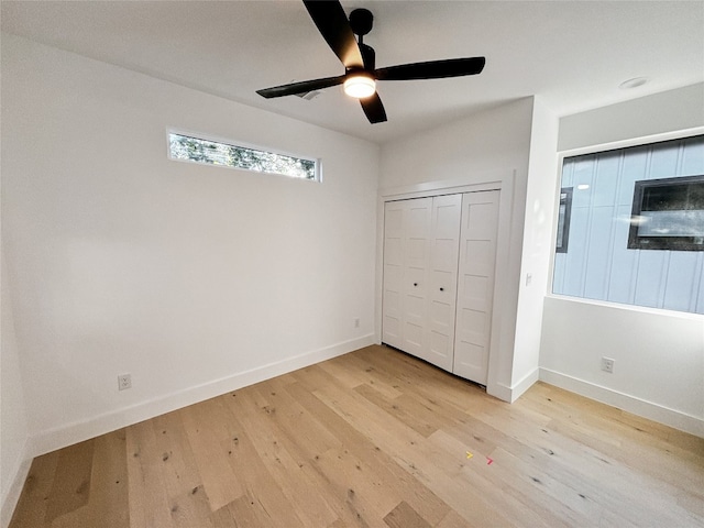 unfurnished bedroom featuring light wood-type flooring, a closet, and ceiling fan