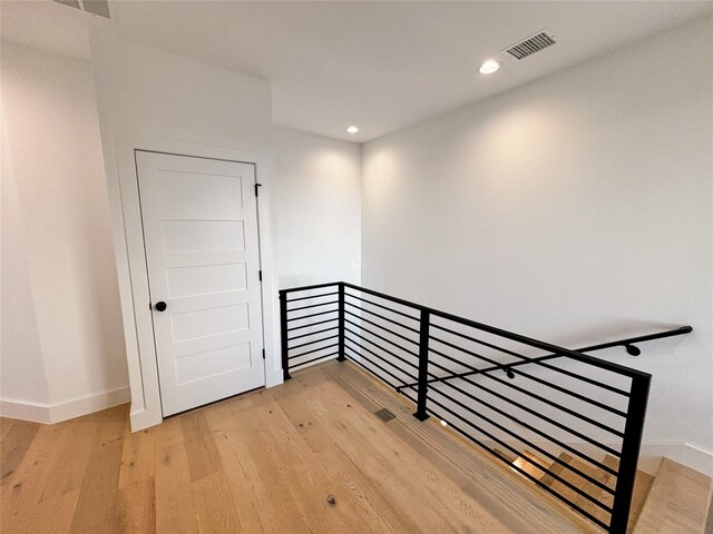 stairs featuring wood-type flooring