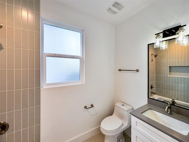 full bathroom with tile patterned flooring, vanity, toilet, and tiled shower / bath combo