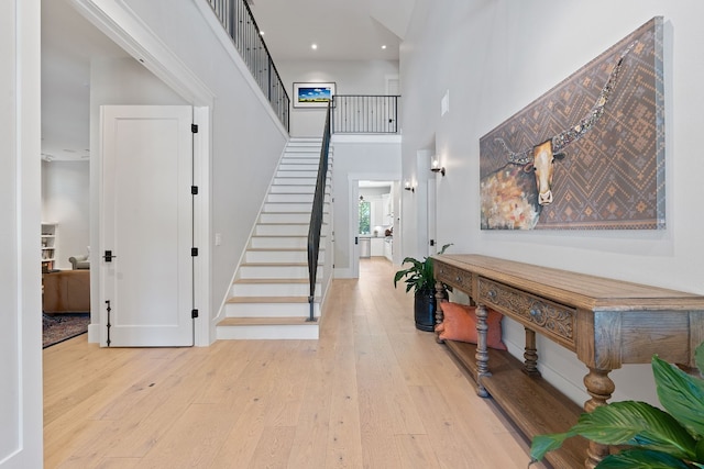 foyer featuring light hardwood / wood-style floors and a high ceiling