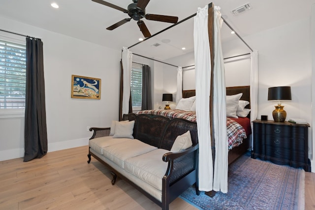 bedroom featuring multiple windows, ceiling fan, and light hardwood / wood-style floors