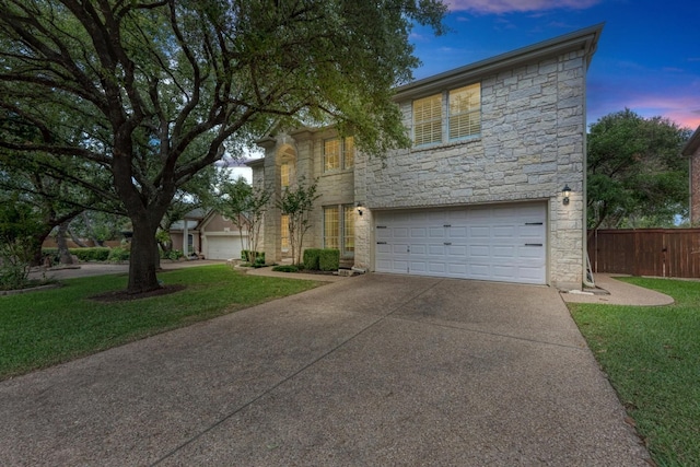 view of front of home featuring a garage and a lawn