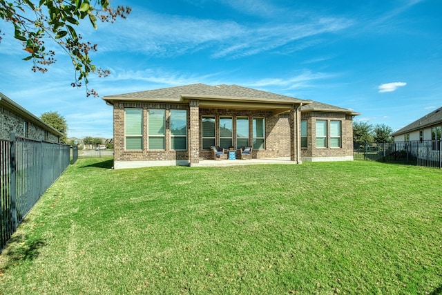 back of house with a patio area and a yard