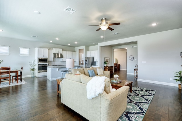 living room with dark hardwood / wood-style floors and ceiling fan