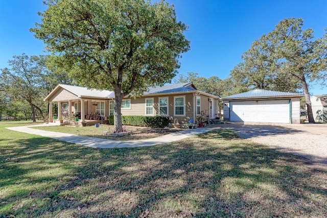 single story home featuring a front lawn, a porch, and a garage