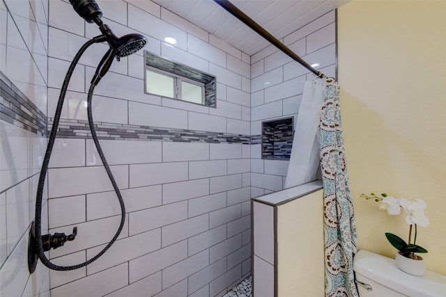 bathroom with a shower with curtain and toilet