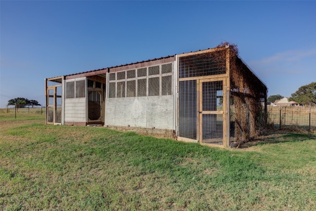 view of outdoor structure with a lawn