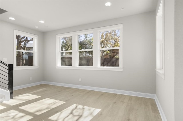 empty room with a healthy amount of sunlight and light wood-type flooring