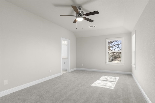 unfurnished room with ceiling fan, light carpet, and vaulted ceiling