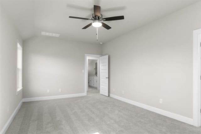 unfurnished bedroom featuring ceiling fan, light colored carpet, and lofted ceiling