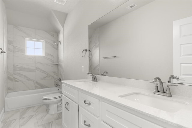 full bathroom with vanity, tiled shower / bath combo, and toilet