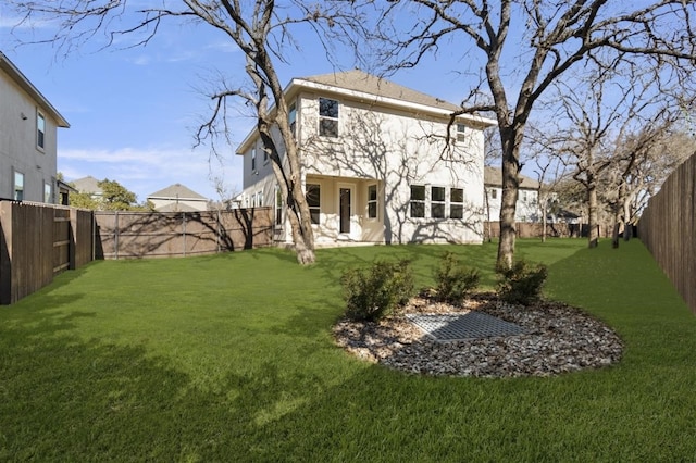 rear view of house featuring a yard