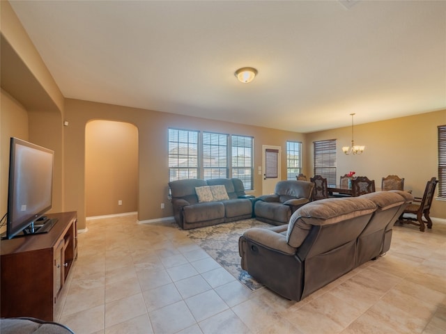 living room with an inviting chandelier and light tile patterned flooring