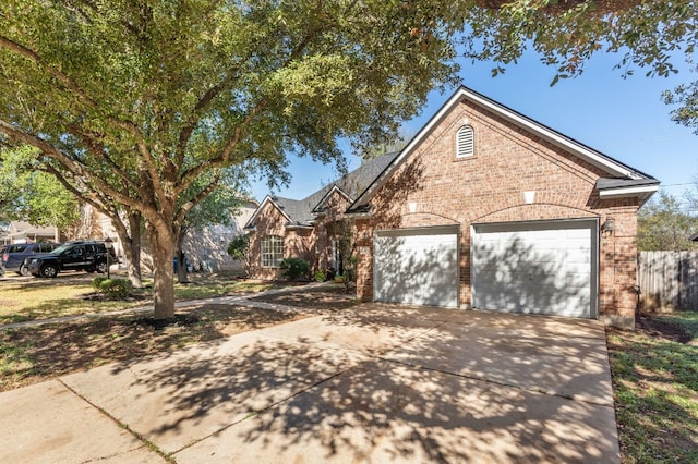 3600 Sawmill Dr, Austin, TX 78749 - view of front of home featuring brick siding, driveway, and an attached garage